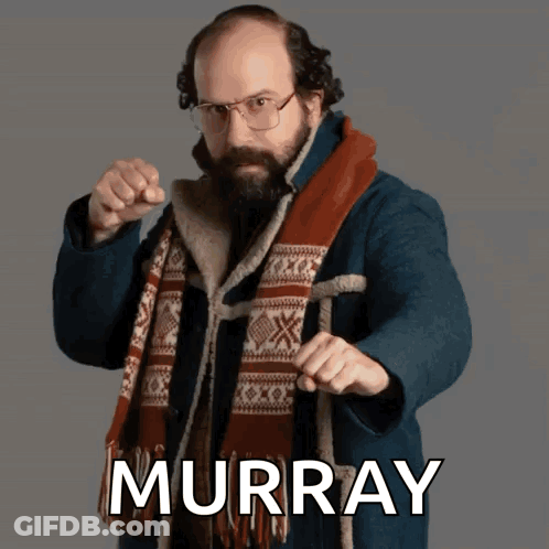 Man In Glasses And Scarf Pointing At Camera Murray GIF