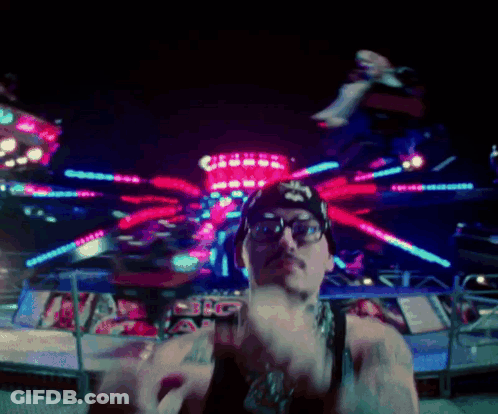 Man In Glasses And Star Hat At Carnival GIF