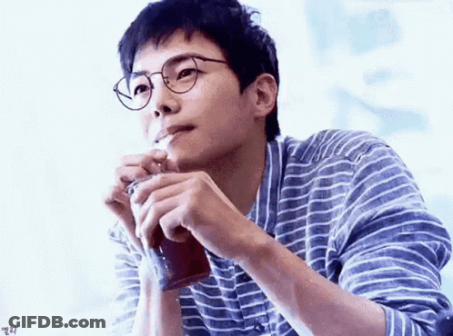 Man In Glasses And Striped Shirt Smoking Cigarette Holding Coffee GIF