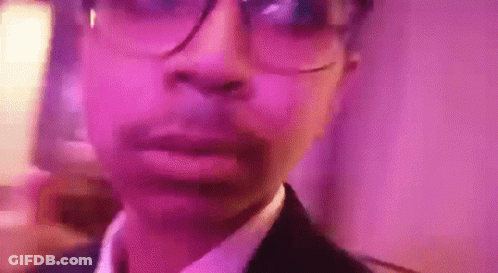 Man In Glasses And Suit At Pink Wall GIF