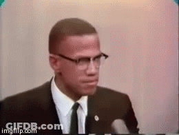 Man In Glasses And Suit Giving Speech At Microphone GIF