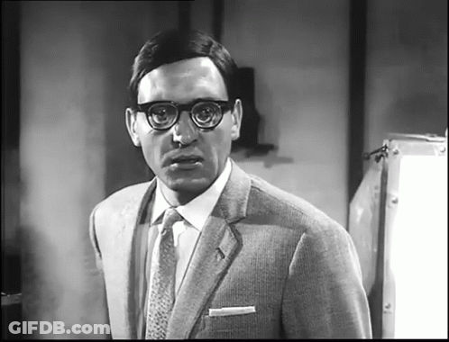 Man In Glasses And Suit Looking At Camera GIF