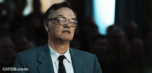 Man In Glasses And Suit Looking At Camera GIF