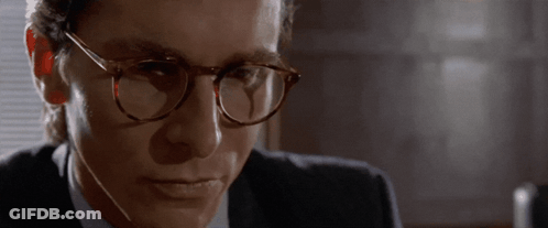 Man In Glasses And Suit Looking At Camera GIF