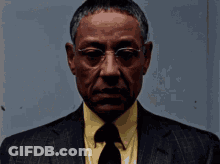 Man In Glasses And Suit Looking At Camera GIF