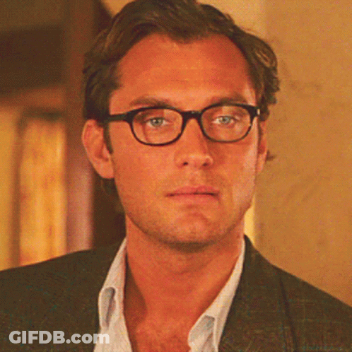 Man In Glasses And Suit Looking At Camera GIF