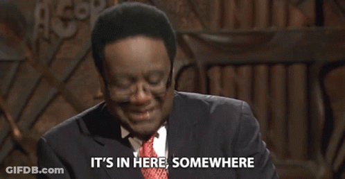 Man In Glasses And Suit Says It's In Here Somewhere GIF
