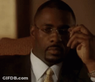 Man In Glasses And Suit Sitting In Chair GIF