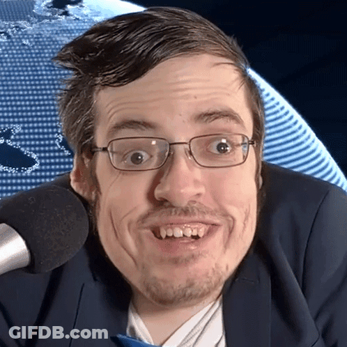 Man In Glasses And Suit Smiling At Microphone GIF