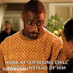 Man In Glasses And Sweater Talking To Another Man GIF