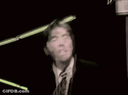 Man In Glasses And Tie Looking At Camera GIF