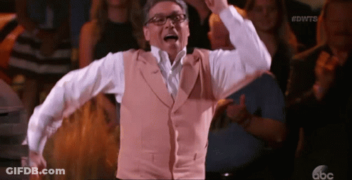 Man In Glasses And Vest Dancing Before Crowd GIF