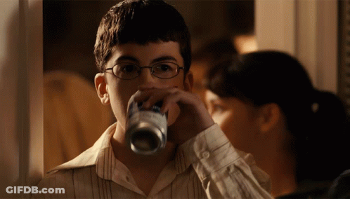 Man In Glasses And Vest In Parking Lot GIF