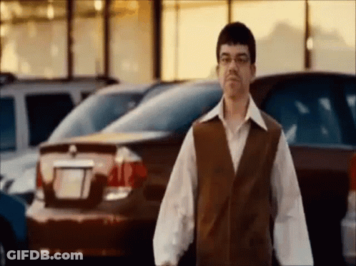 Man In Glasses And Vest In Parking Lot GIF