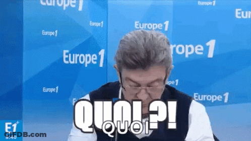 Man In Glasses And Vest Sitting In Front Of Europe 1 Wall GIF