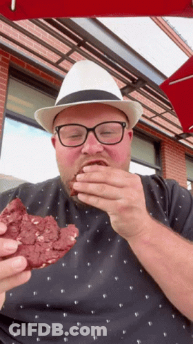 Man In Glasses And White Hat Eating Cookie GIF