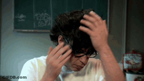 Man In Glasses And White Shirt Holding Hair GIF