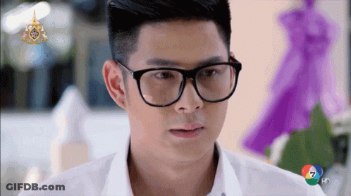 Man In Glasses And White Shirt Looking At Camera GIF