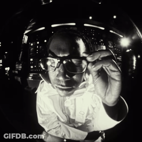 Man In Glasses And White Shirt Looking At Camera GIF