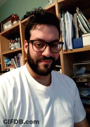 Man In Glasses And White Shirt With Book Tab GIF