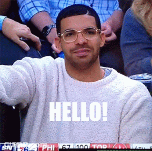 Man In Glasses And White Sweater Saying Hello GIF