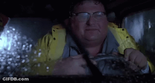 Man In Glasses And Yellow Jacket Driving In Rain GIF