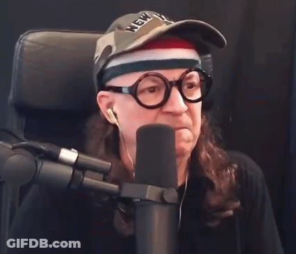 Man In Glasses And York Hat Says Boo Into Microphone GIF
