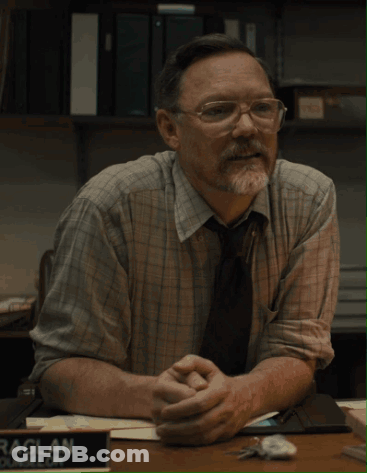 Man In Glasses At Desk With Raglan Sign GIF