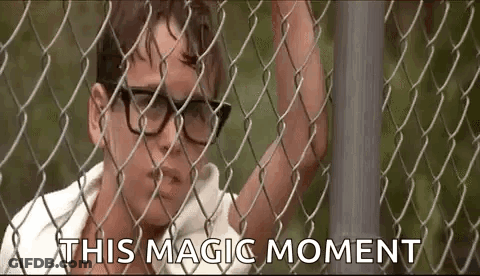 Man In Glasses Behind Chain Link Fence Saying This Magic Moment GIF