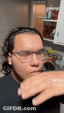 Man In Glasses Hand On Mouth In Kitchen GIF