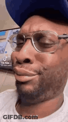 Man In Glasses, Hat, White Shirt Making Funny Face GIF