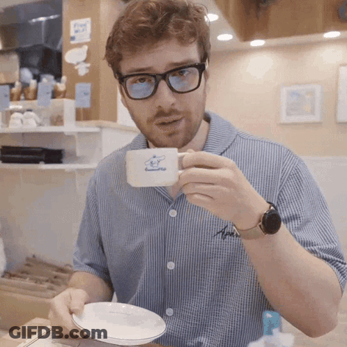 Man In Glasses Holding Coffee Cup With Sheep GIF