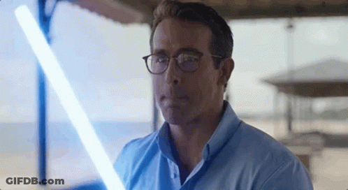 Man In Glasses Holding Light Saber GIF