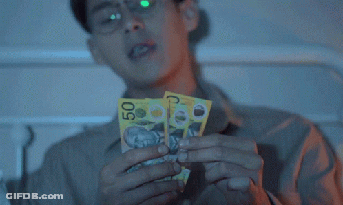 Man In Glasses Holding Two Pill Packets GIF
