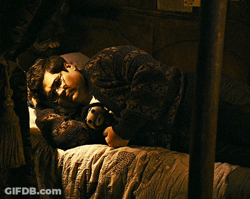 Man In Glasses Lying On Bed With Stuffed Animal GIF