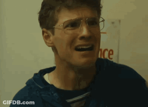 Man In Glasses Making Funny Face Beside Ance Sign GIF