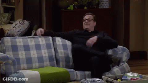 Man In Glasses On Blue Plaid Couch GIF
