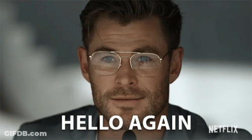 Man In Glasses Saying Hello Again On Netflix Screen GIF