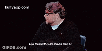 Man In Glasses Sitting In Chair Saying Love Them As They Are Or Leave Them Be GIF