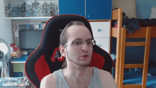 Man In Glasses Sitting In Red And Black Chair GIF