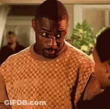 Man In Glasses Talking To Woman In Living Room GIF