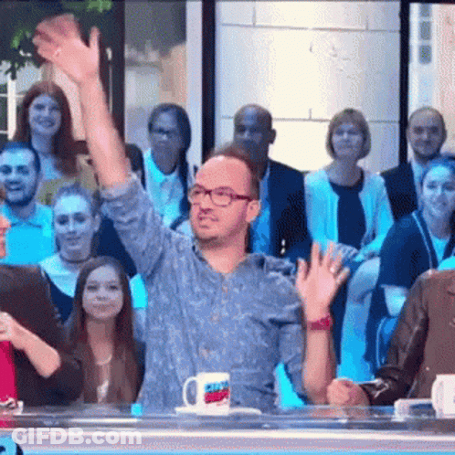 Man In Glasses Waving At Crowd GIF