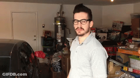 Man In Glasses With 6 Gallon Box In Garage GIF
