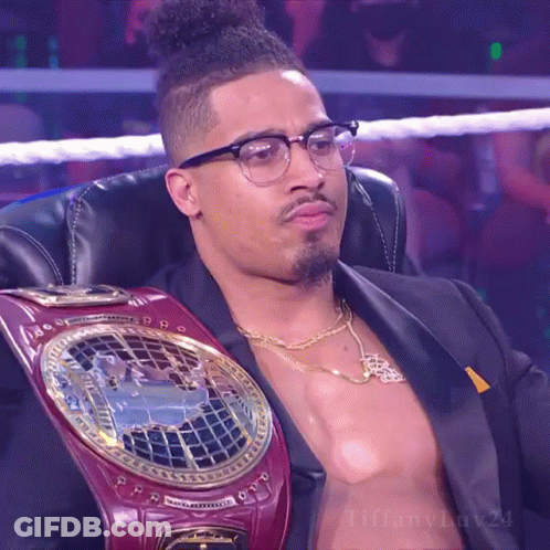 Man In Glasses With Heavyweight Championship Belt Sitting GIF