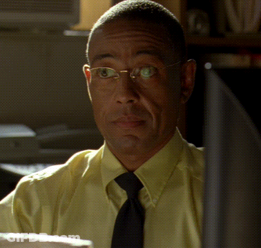 Man In Glasses Yellow Shirt And Tie Looking At Camera GIF