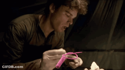 Man In Gloves Holding Pink Object GIF