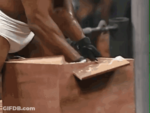 Man In Gloves Lifting Large Brown Box GIF