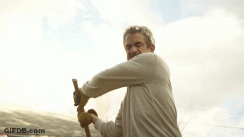 Man In Gloves Swinging Hammer GIF