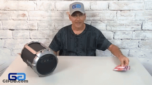 Man In Go Hat Sitting At Table Next To Boombox GIF