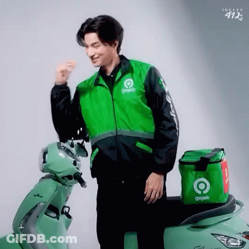 Man In Gojek Jacket Next To Green Scooter GIF